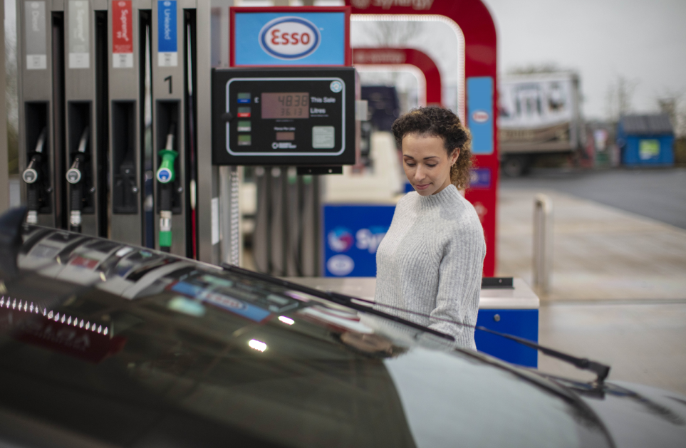 Woman fueling card at an Esso fuel station